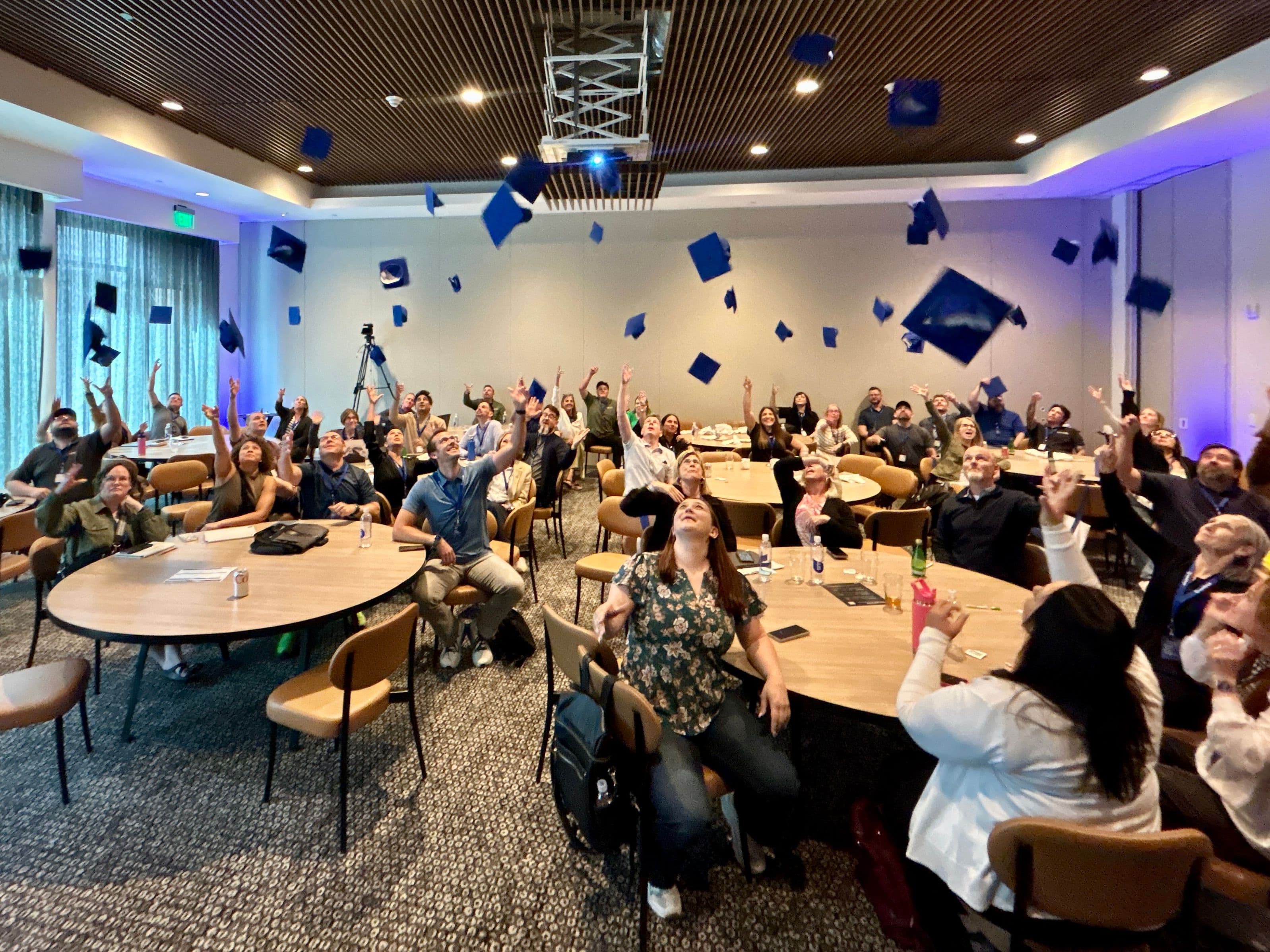 LeadSimple University 2026 attendees toss graduation caps to commemorate completion of the workshops